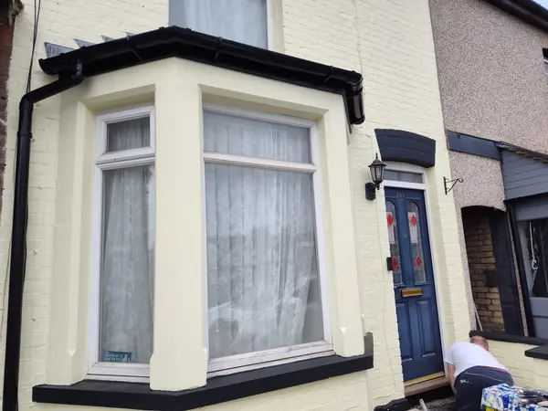 Exterior house painting at 101 Cecil Street, Watford — finished cream facade with blue door