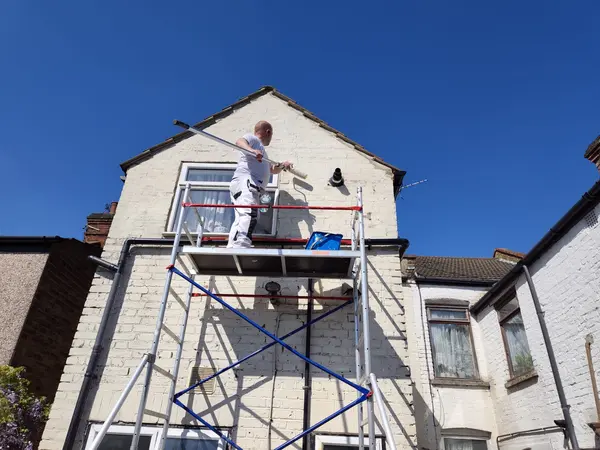 Cecil Street, Watford — exterior painting in progress, scaffold tower against rear gable
