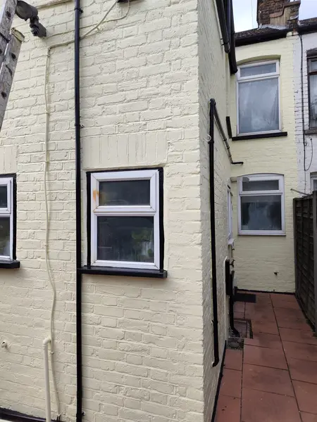 Cecil Street, Watford — finished rear elevation, clean cream brick and black pipework