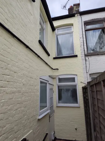 Cecil Street, Watford — finished side wall, crisp cream and black contrast