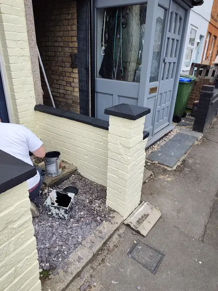 Cecil Street, Watford — finished garden wall pillars with new black painted caps