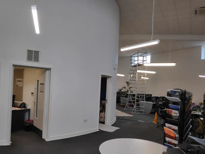 Milton Keynes Academy, Milton Keynes — high-ceiling classroom with a round table, freshly painted in white
