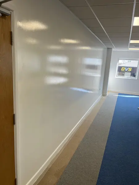 Whiteboard wall painting — glossy dry-erase finish on long office wall