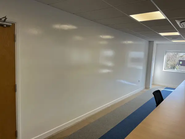 Whiteboard wall painting — full-length view of office meeting room wall